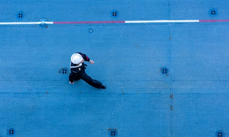 A seafarer walking holding Seafarers Identity Document (SID) in his hand